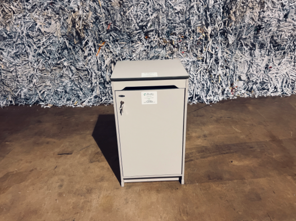 A small white refrigerator sitting in front of a wall.