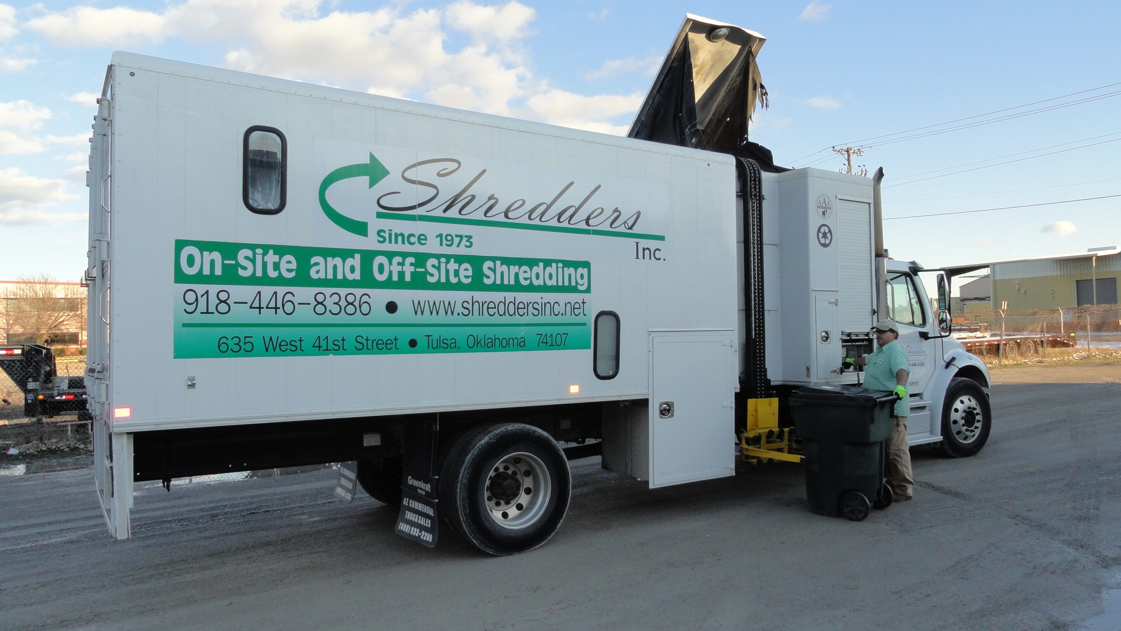 A large white truck with the words " shredder ".